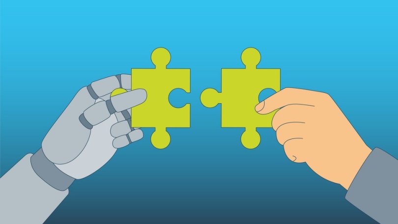 A robotic hand and a human hand are each holding a green puzzle piece that are meant to be put together.